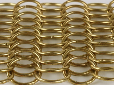 Golden chainmail curtain on the white background can be placed into fish scale shape.