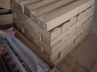 Many packaged cartons pile up together on the ground, and two packaging cartons beside them.