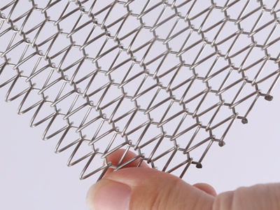 A piece of small size wire mesh belt is held in one's hand.