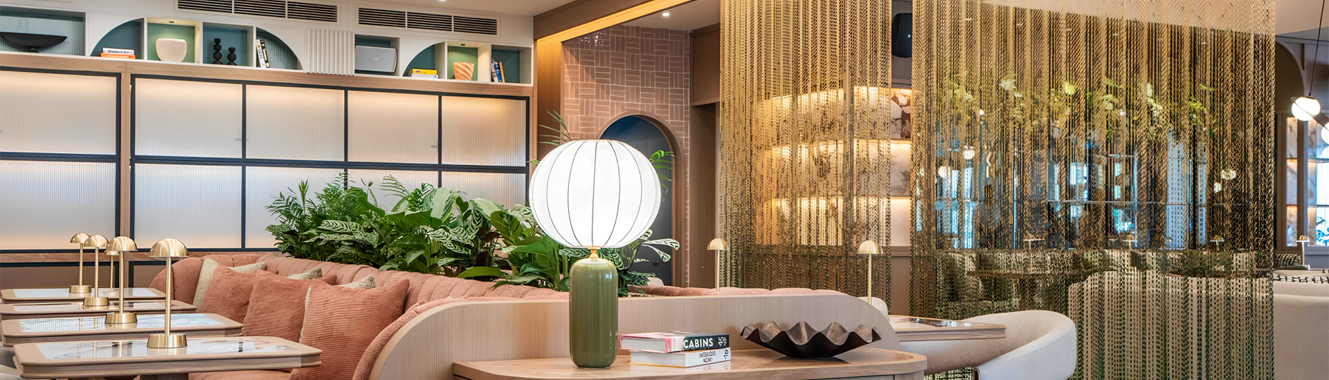 Golden chain link curtain used as a partition in a high-end restaurant.
