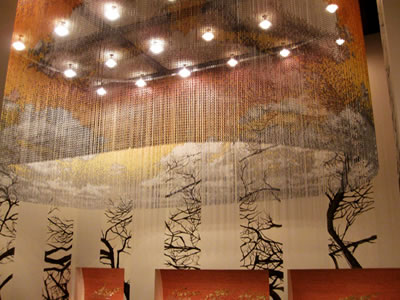 Chain link printing curtain with bright lamps hanging on the ceiling decorates potted landscape.