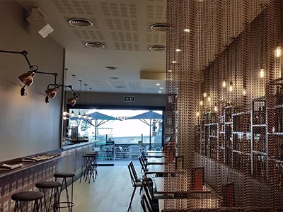 The dining room is separated by a chain link curtain