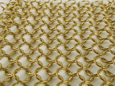 An enlarged view of golden chainmail curtain on the white background.