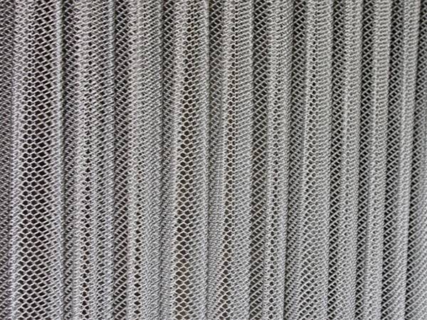 A piece of metal coil curtain with 200% fullness effectiveness.