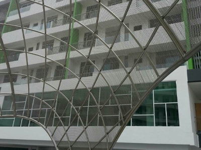 Metal coil drapery used as an outdoor sunshade