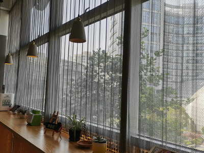 Metal coil drapery used as a sunshade