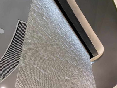 Metal coil drapery used as a water curtain