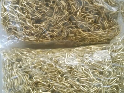 Two plastic bags of chain link curtain, one bag is yellow chain link curtain, the other is in golden color.