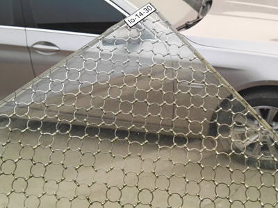 Ring mesh curtain laminated glass, and there is a car beside it.